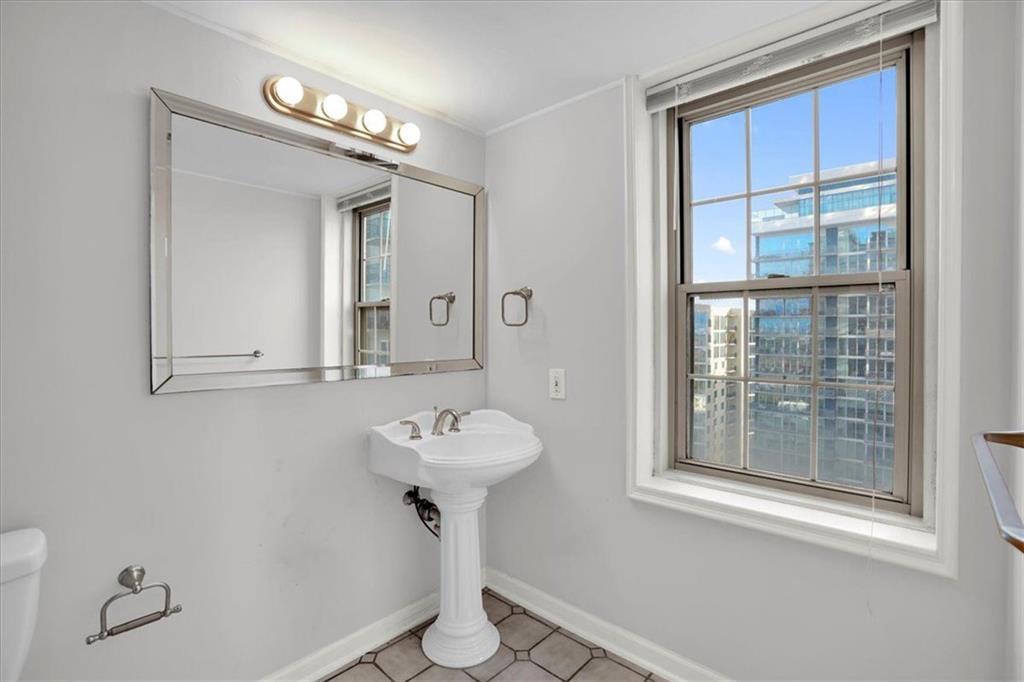 199 14th Street Northeast, Unit 2308 Atlanta, GA 30309 - Photo 21 of 35 a bathroom with a sink and mirror