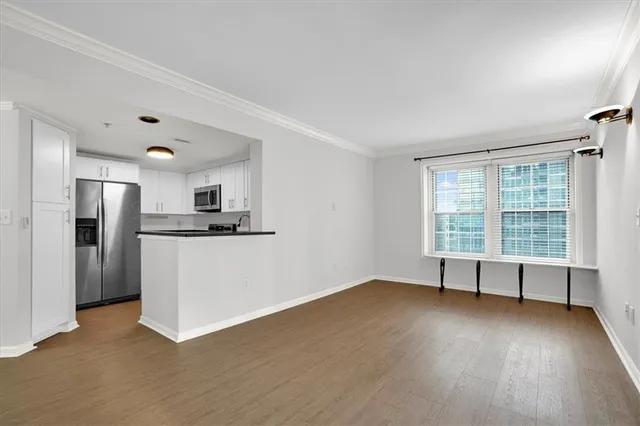a view of a room with wooden floor and windows
