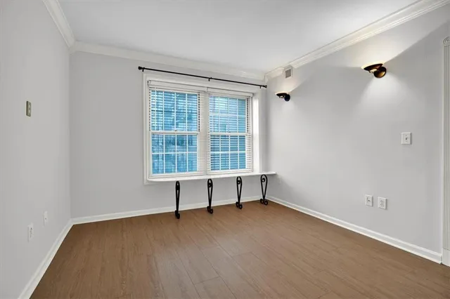 a kitchen with stainless steel appliances granite countertop a refrigerator a sink a stove a microwave and white cabinets