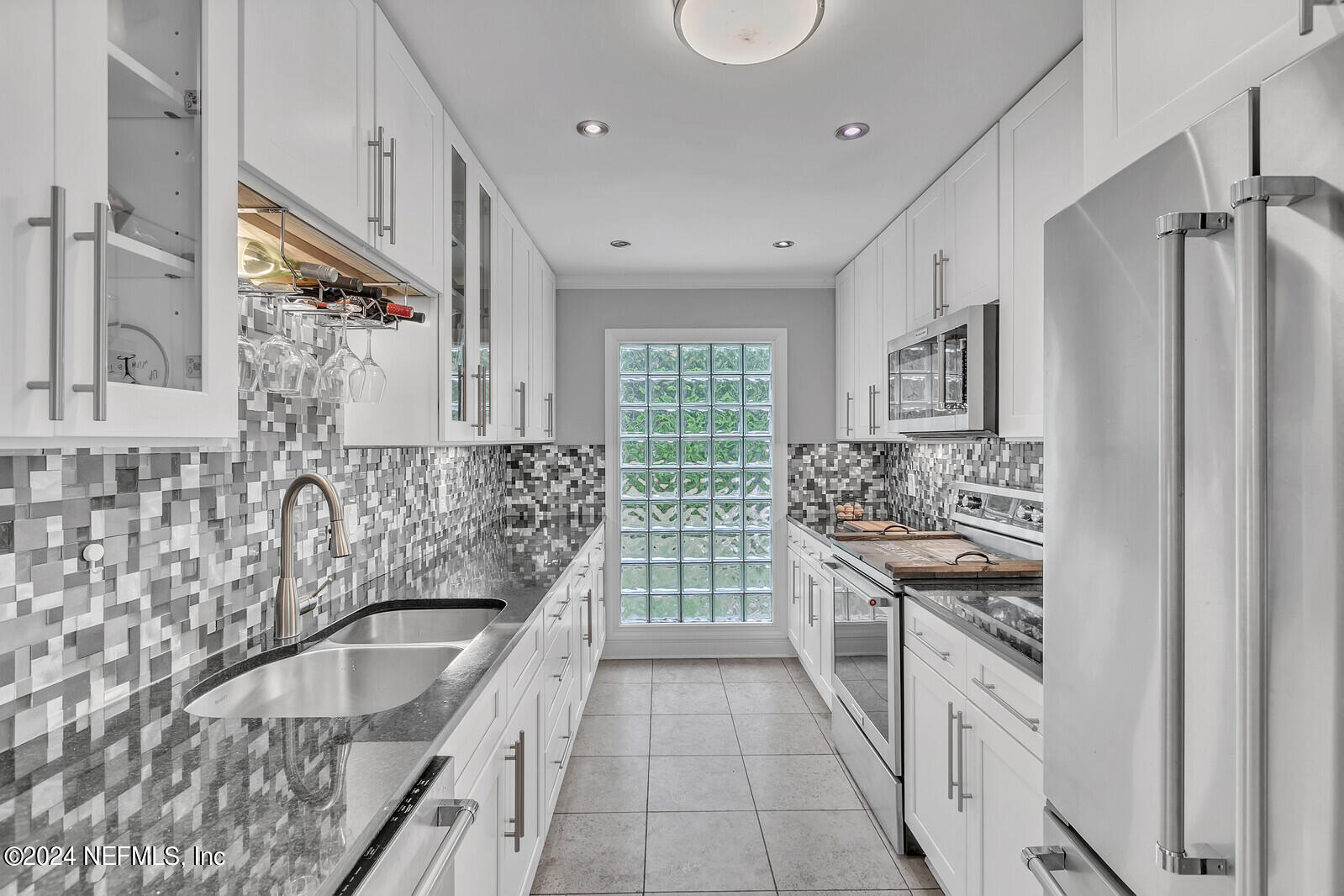 6695 Highway 16 St. Augustine, FL 32092 - Photo 11 of 46 a kitchen with granite countertop a sink stove and refrigerator