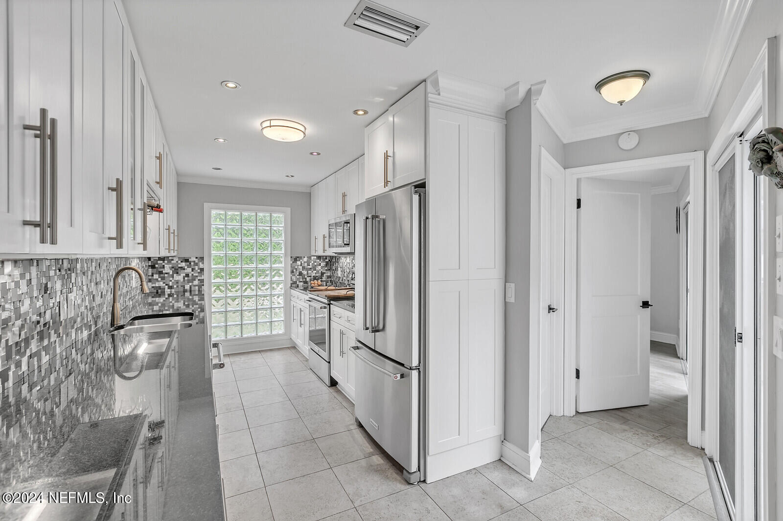 6695 Highway 16 St. Augustine, FL 32092 - Photo 12 of 46 a kitchen with stainless steel appliances granite countertop a refrigerator and a stove