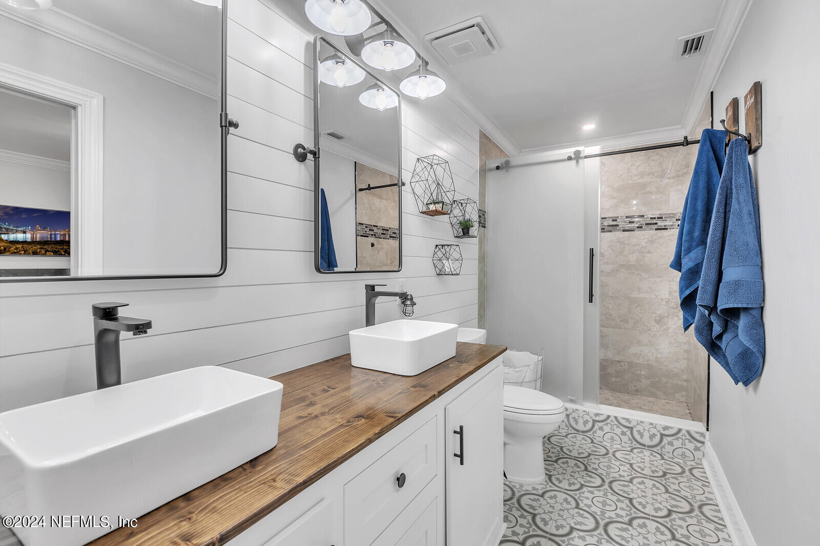 6695 Highway 16 St. Augustine, FL 32092 - Photo 16 of 46 a bathroom with a sink and mirror with toilet