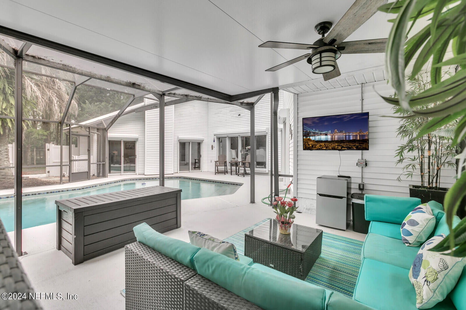 6695 Highway 16 St. Augustine, FL 32092 - Photo 25 of 46 a living room with furniture a rug and a chandelier