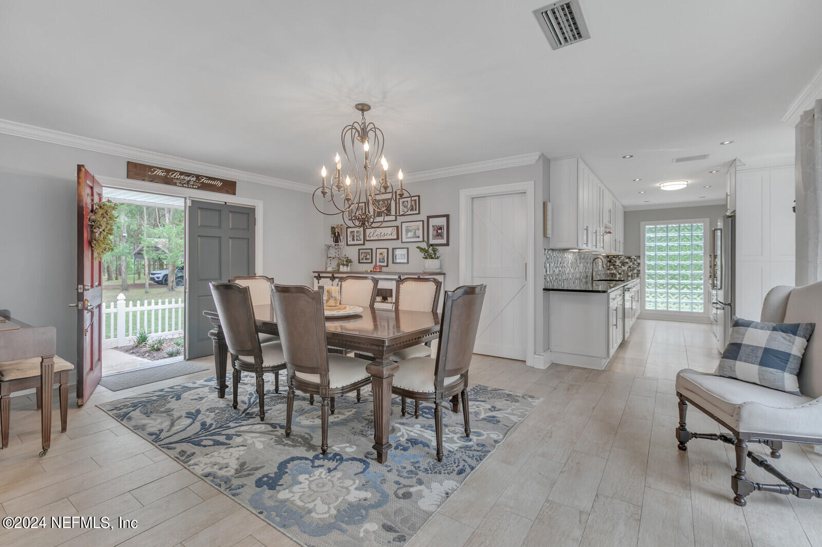 6695 Highway 16 St. Augustine, FL 32092 - Photo 5 of 46 a view of a dining room with furniture a chandelier and wooden floor