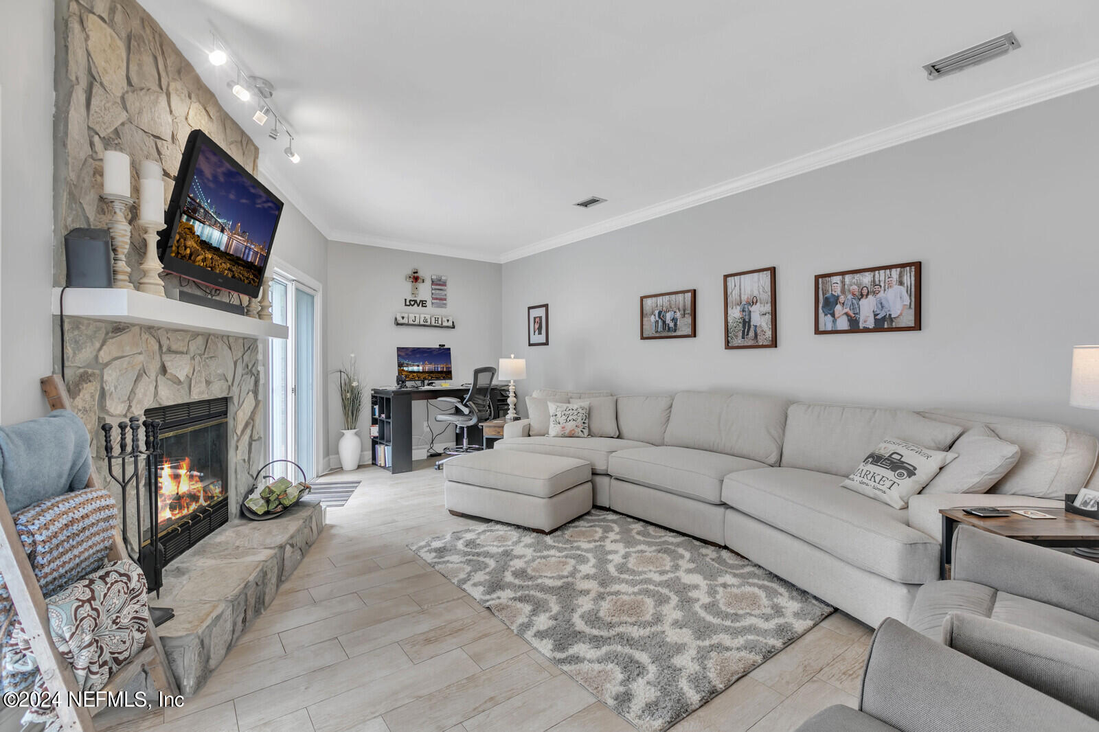 6695 Highway 16 St. Augustine, FL 32092 - Photo 9 of 46 a living room with furniture a flat screen tv and a fireplace