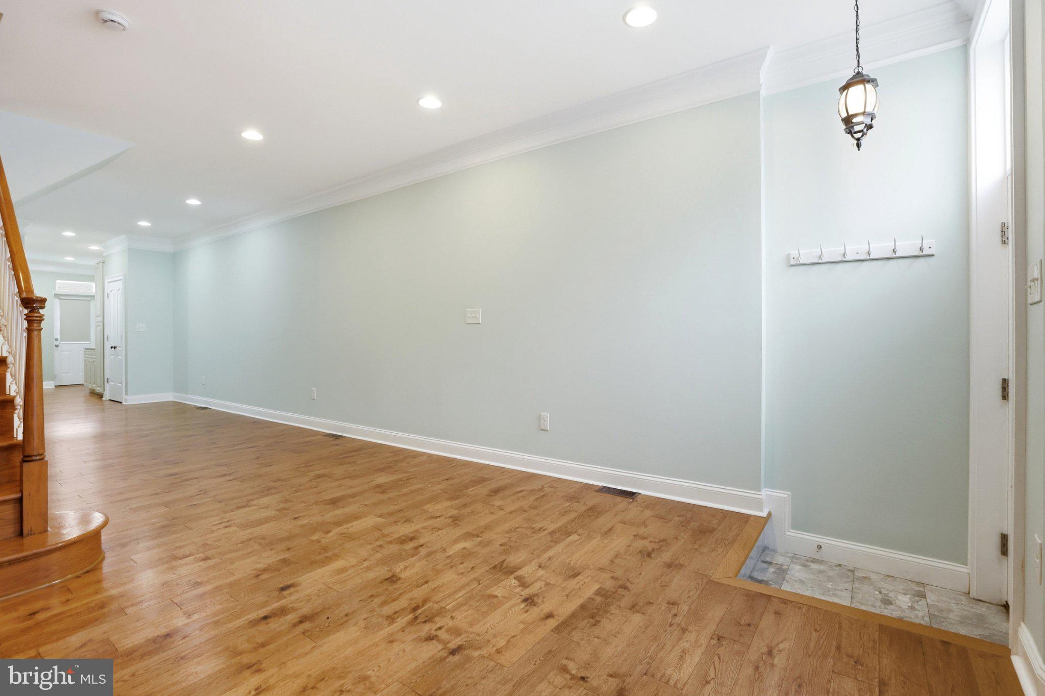 222 South Exeter Street Baltimore, MD 21202 - Photo 4 of 41 an empty room with wooden floor and a window