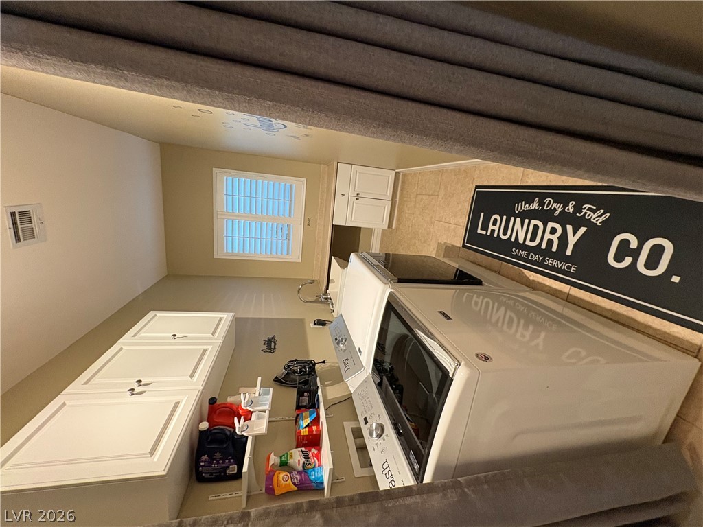 977 Rhyolite Terrace Henderson, NV 89011 - Photo 17 of 33 Functional workspace features built-in cabinetry, tile flooring, and a dedicated laundry area.