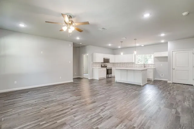 a view of kitchen with wooden floor and window
