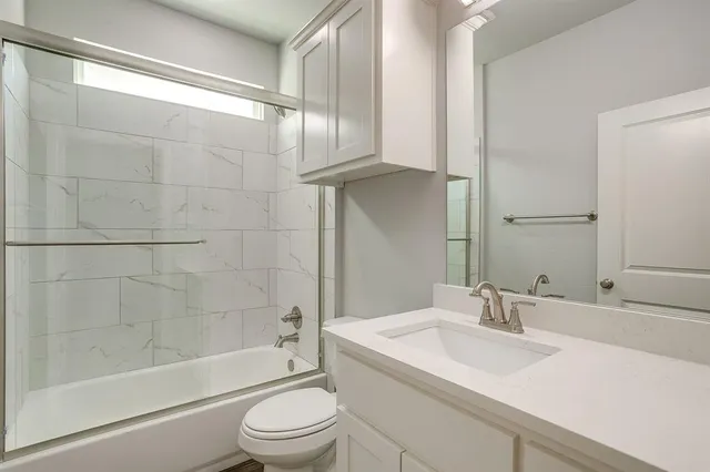 a bathroom with a sink a toilet and a bathtub