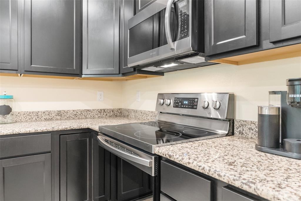 6283 Grapewood Road Spring Hill, FL 34609 - Photo 18 of 41 a kitchen with a stove and a microwave