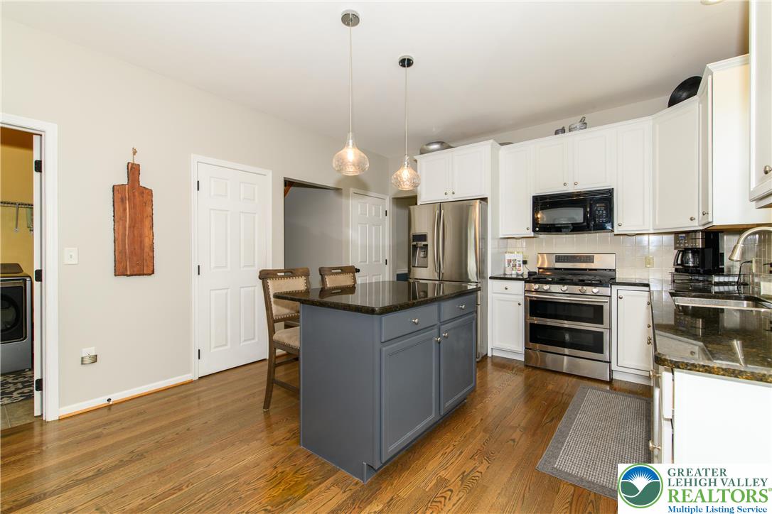 1286 Keller Road Wind Gap, PA 18091 - Photo 6 of 59 a kitchen with stainless steel appliances a stove a sink a microwave a refrigerator and white cabinets