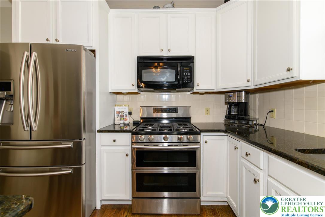 1286 Keller Road Wind Gap, PA 18091 - Photo 7 of 59 a kitchen with stainless steel appliances granite countertop a refrigerator stove and microwave