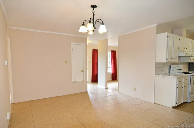 a view of a kitchen with stainless steel appliances granite countertop a stove a sink and a refrigerator
