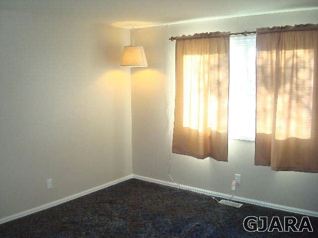 842 21 Road Fruita, CO 81521 - Photo 9 of 35 a view of an empty room and window