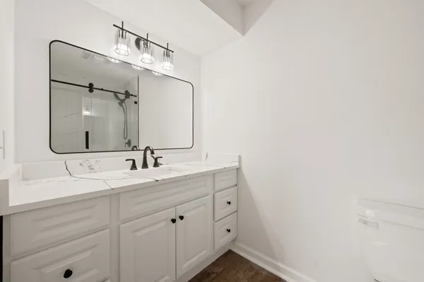 a white toilet sitting next to a shower