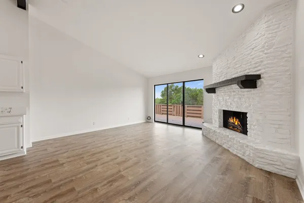 a view of a room wooden floor and a fireplace