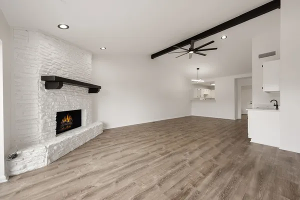 a view of empty room with a fireplace
