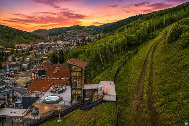 1258 Rothwell Road Park City, UT 84060 - Photo 41 of 48 Multi-level outdoor deck featuring a hot tub, a fire pit, and a glass-enclosed structure