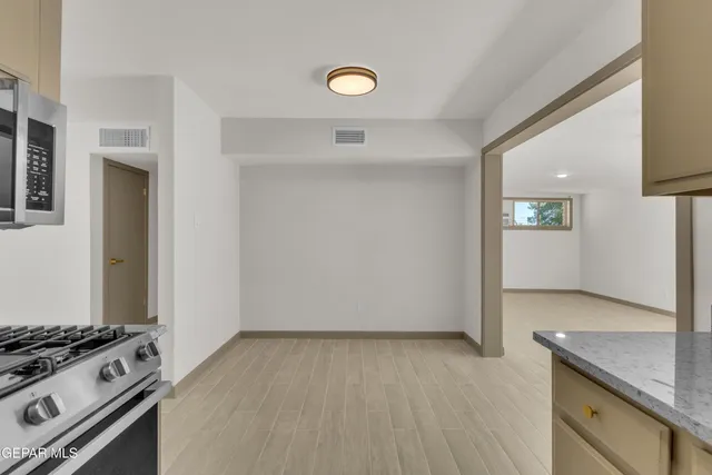 a view of a kitchen with a stove top oven