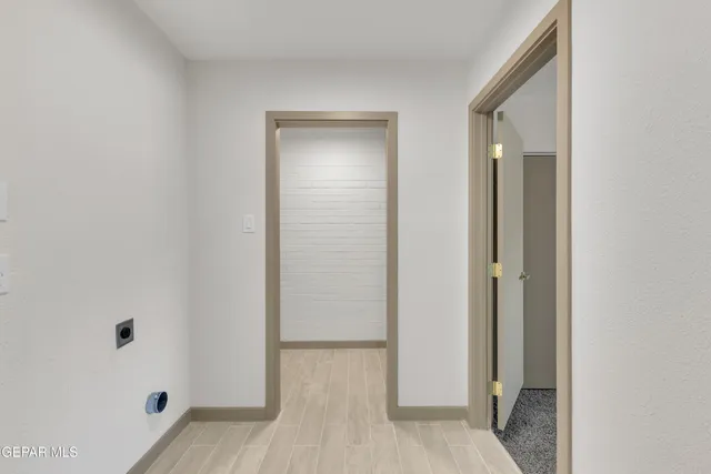 an empty room with wooden floor and closet