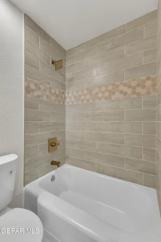 a bathroom with a bathtub and a toilet