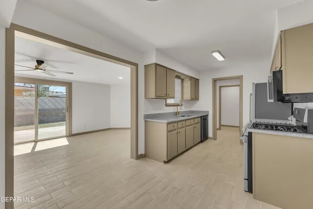 a kitchen with a sink stove and cabinets