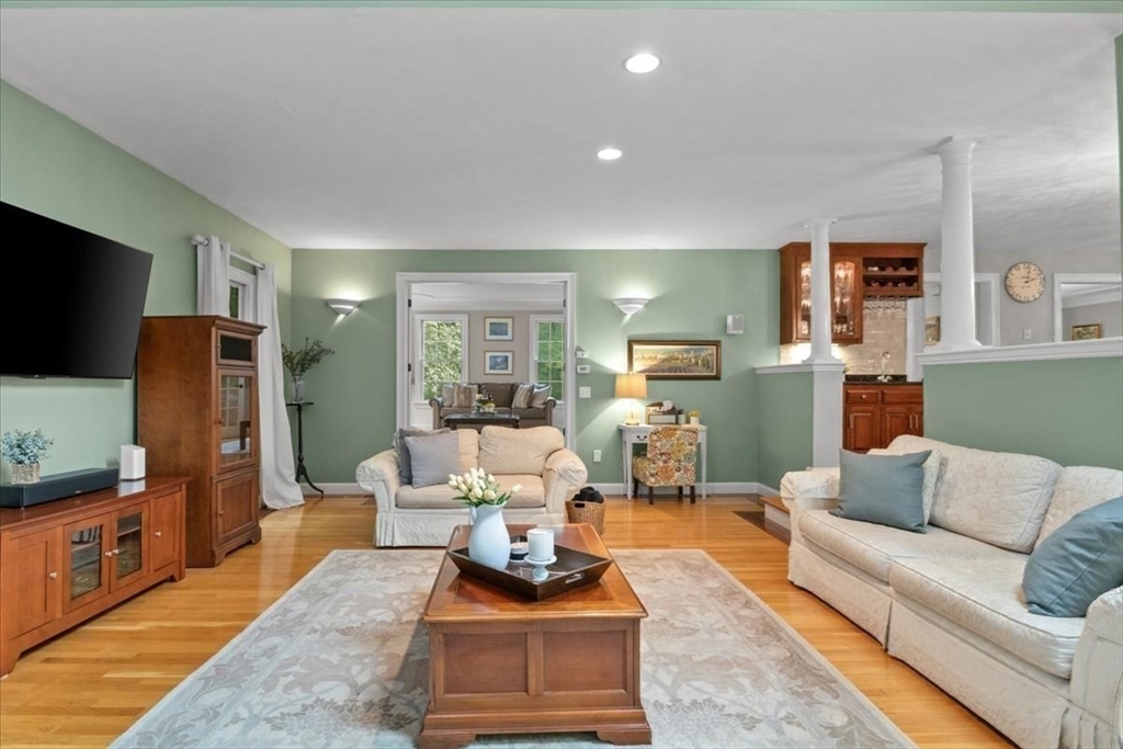 22 Dover Drive Walpole, MA 02081 - Photo 16 of 41 a living room with furniture a flat screen tv and a refrigerator