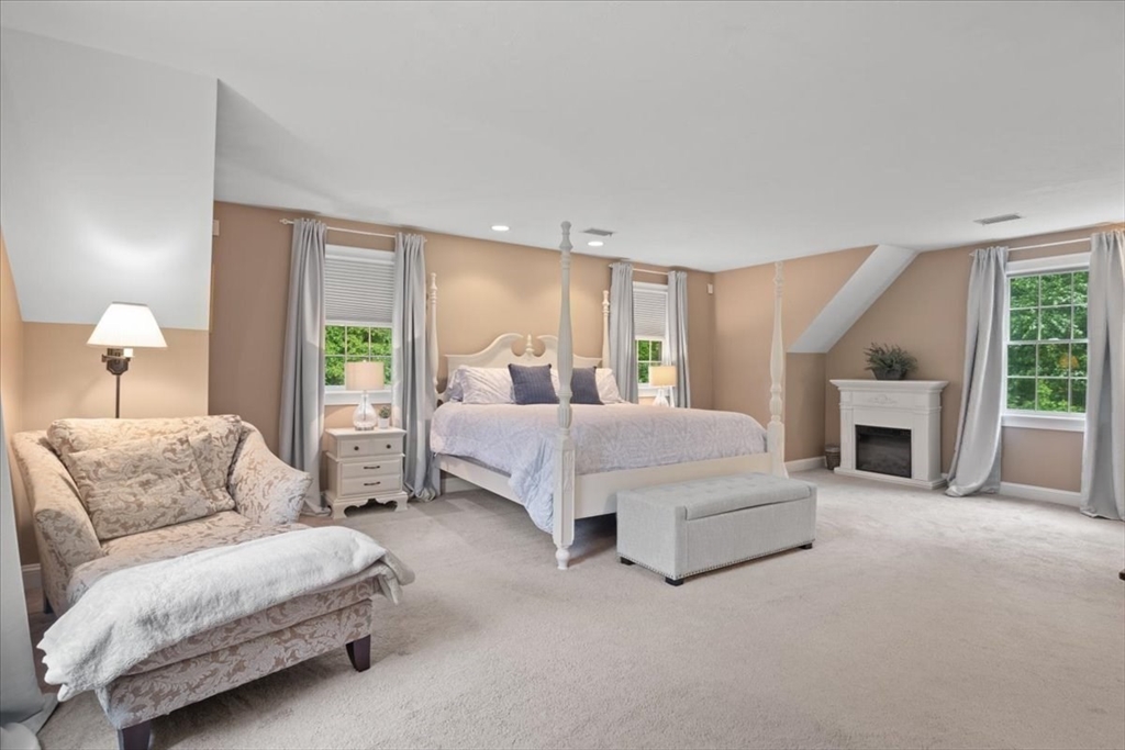 22 Dover Drive Walpole, MA 02081 - Photo 22 of 41 a spacious bedroom with a bed and a fireplace