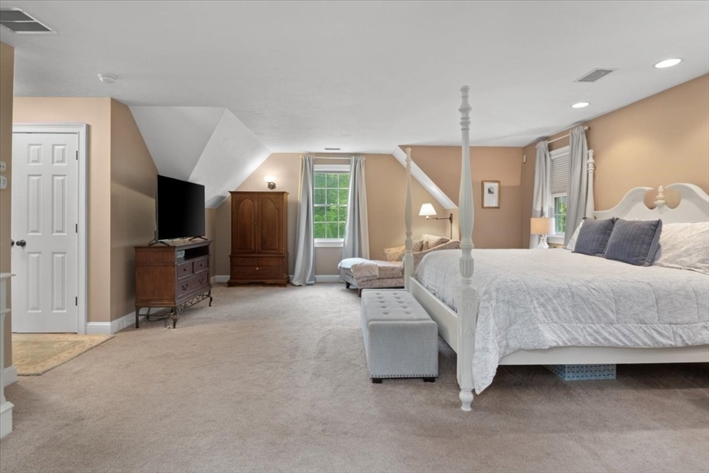 22 Dover Drive Walpole, MA 02081 - Photo 23 of 41 a bedroom with a bed and a chandelier