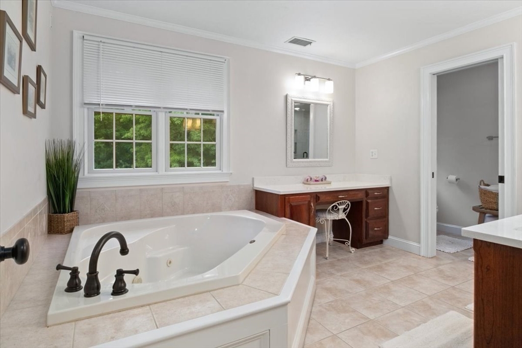 22 Dover Drive Walpole, MA 02081 - Photo 24 of 41 a bathroom with a tub a sink a mirror and a window