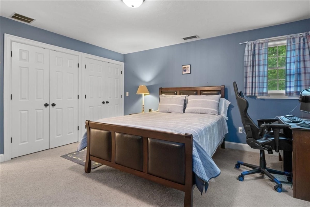 22 Dover Drive Walpole, MA 02081 - Photo 31 of 41 a bedroom with a bed and a table in it