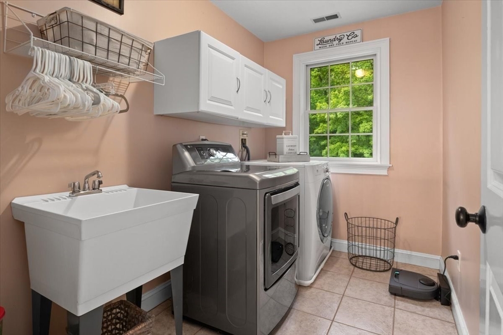 22 Dover Drive Walpole, MA 02081 - Photo 32 of 41 a utility room with cabinets dryer and washer