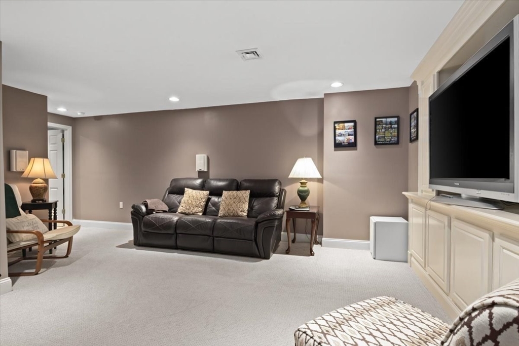 22 Dover Drive Walpole, MA 02081 - Photo 36 of 41 a living room with furniture and a flat screen tv