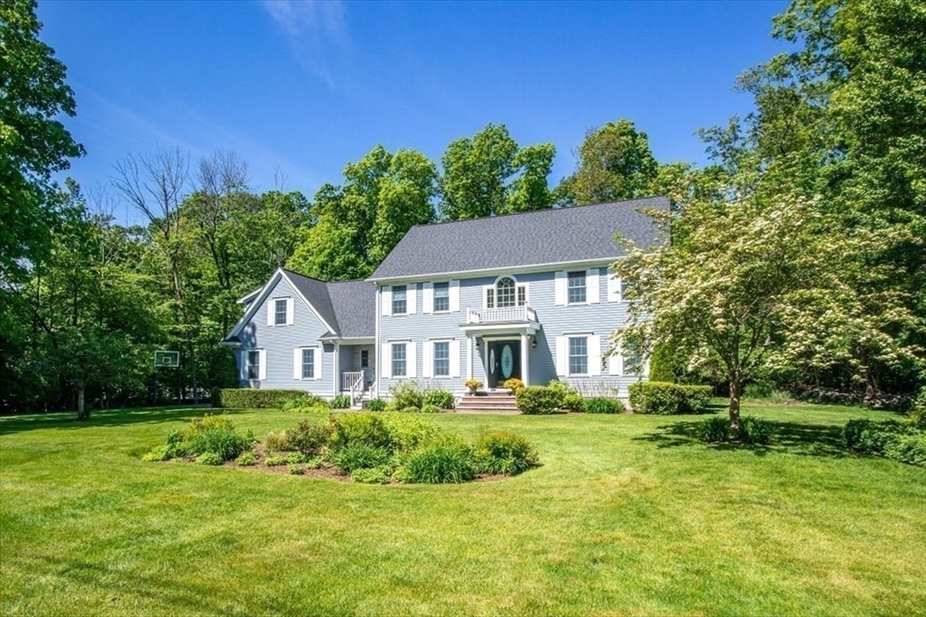 22 Dover Drive Walpole, MA 02081 - Photo 4 of 41 a front view of a house with a yard
