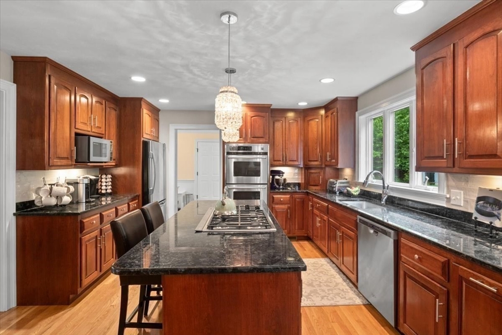 22 Dover Drive Walpole, MA 02081 - Photo 7 of 41 a large kitchen with stainless steel appliances granite countertop plenty wooden cabinets counter space and a sink