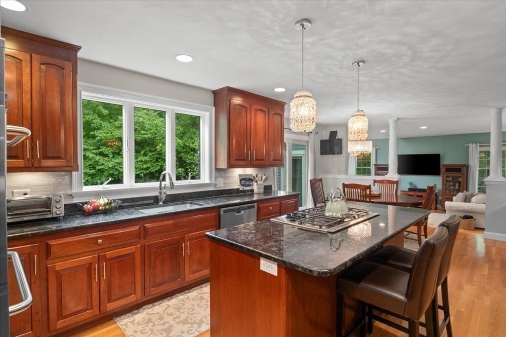 22 Dover Drive Walpole, MA 02081 - Photo 9 of 41 a kitchen with a sink a counter top space and living room view