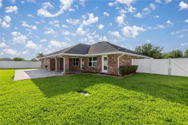 a view of a house with a backyard