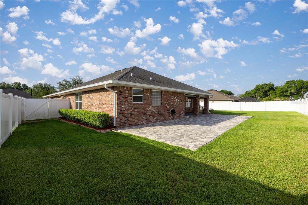 4441 Southwest 62nd Loop Ocala, FL 34474 - Photo 13 of 42 a front view of a house with a yard