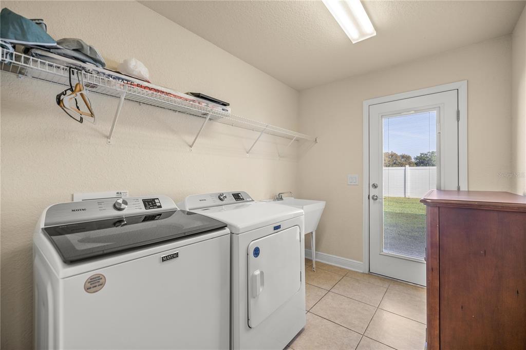 4441 Southwest 62nd Loop Ocala, FL 34474 - Photo 26 of 42 a utility room with cabinets washer and dryer