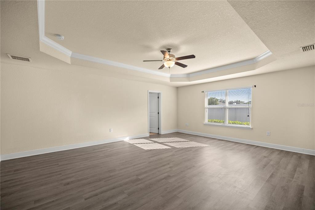 4441 Southwest 62nd Loop Ocala, FL 34474 - Photo 28 of 42 a view of an empty room with a window and a ceiling fan