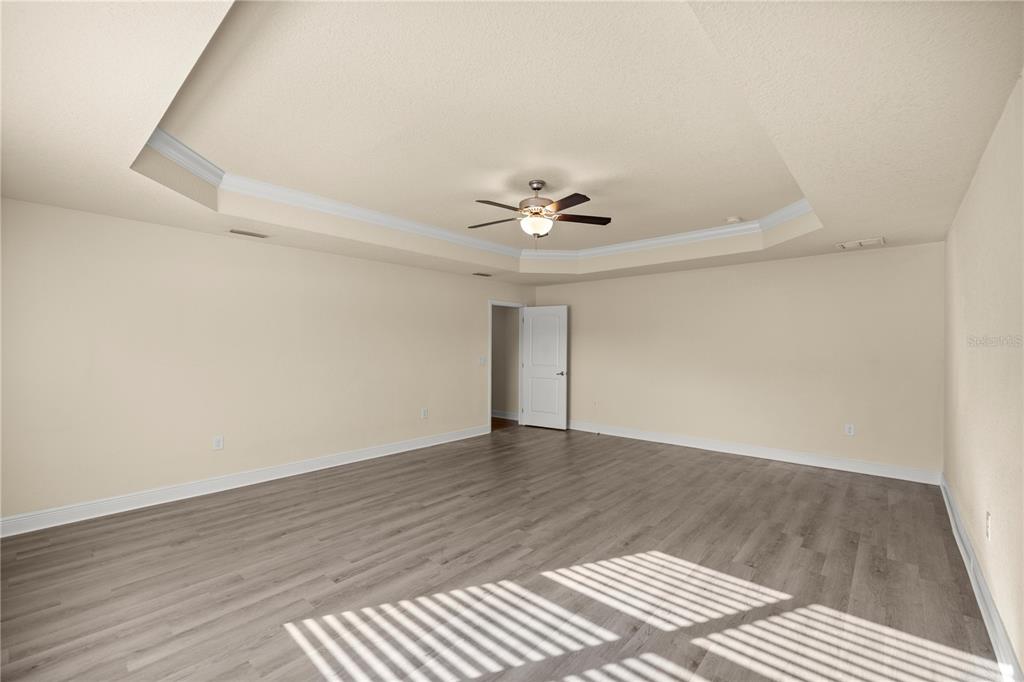 4441 Southwest 62nd Loop Ocala, FL 34474 - Photo 29 of 42 a view of an empty room with wooden floor