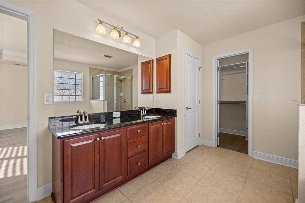 4441 Southwest 62nd Loop Ocala, FL 34474 - Photo 31 of 42 a spacious bathroom with a granite countertop sink mirror and a