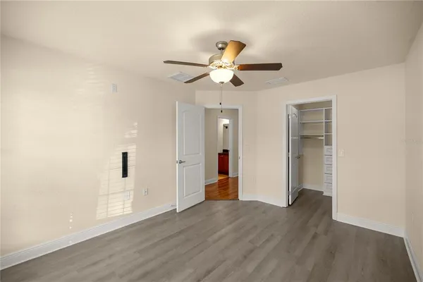 a view of an empty room with wooden floor