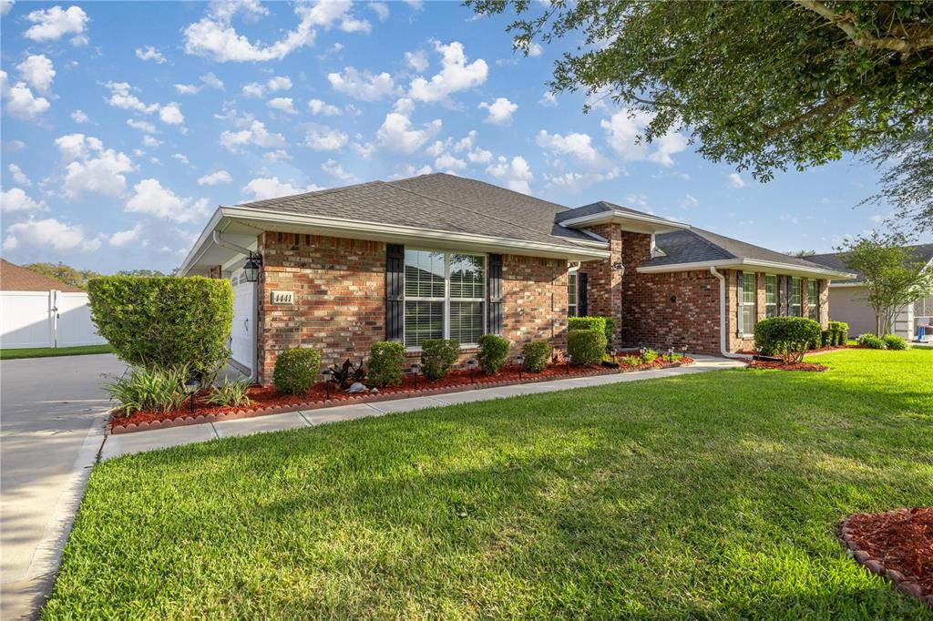 4441 Southwest 62nd Loop Ocala, FL 34474 - Photo 8 of 42 a front view of a house with garden