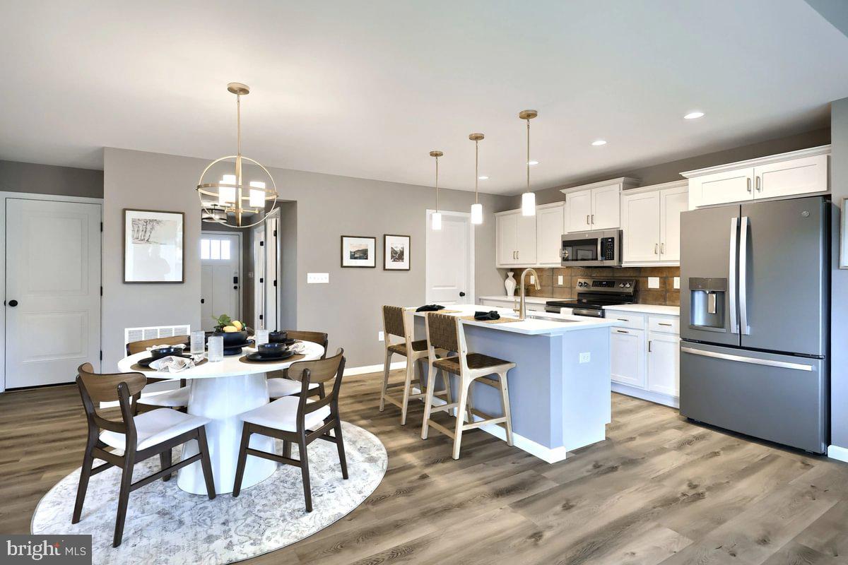 126 Redbud Road Bellefonte, PA 16823 - Photo 8 of 16 a kitchen with stainless steel appliances kitchen island granite countertop a table chairs and a refrigerator