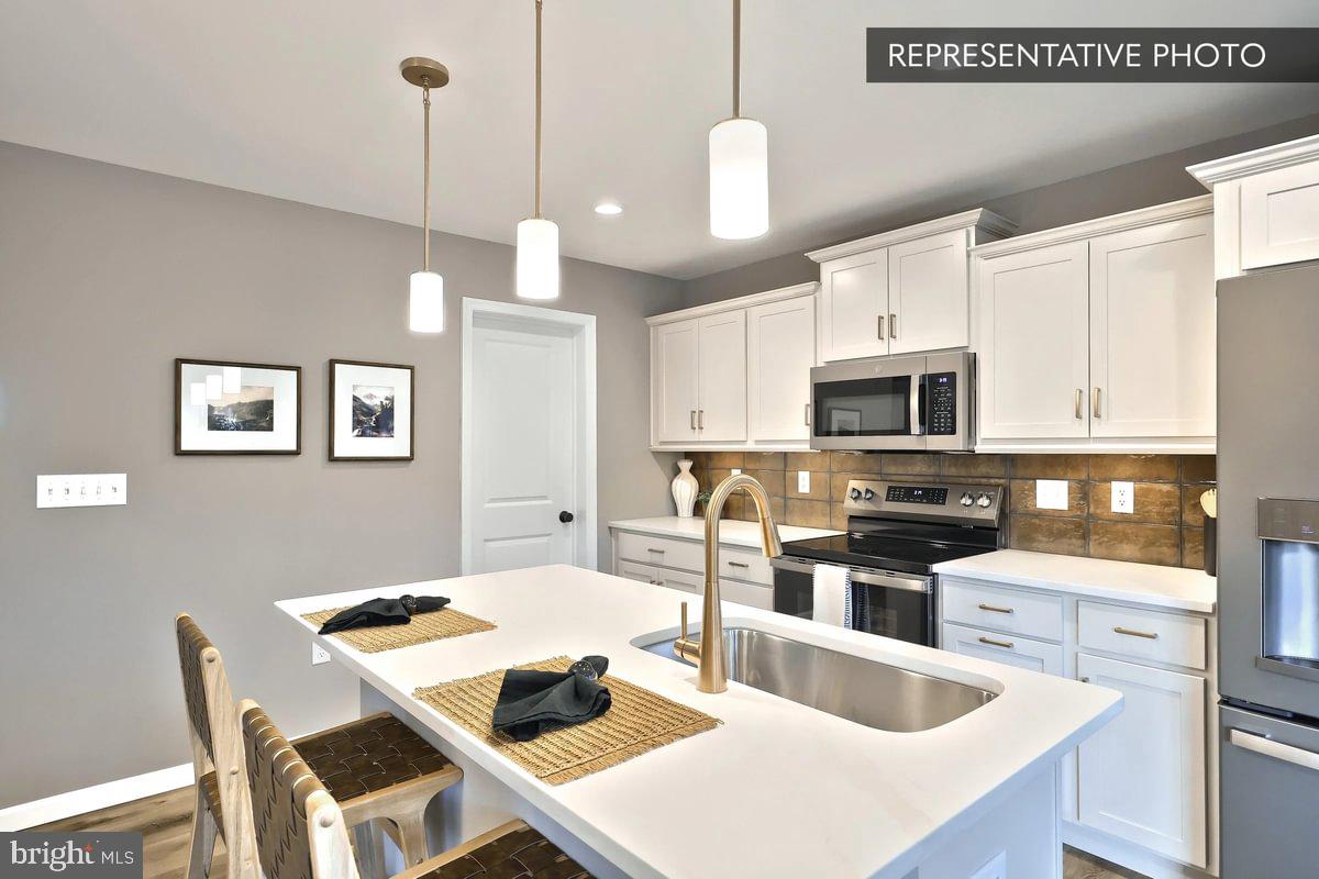126 Redbud Road Bellefonte, PA 16823 - Photo 9 of 16 a kitchen with stainless steel appliances kitchen island granite countertop a sink a stove a dining table and chairs