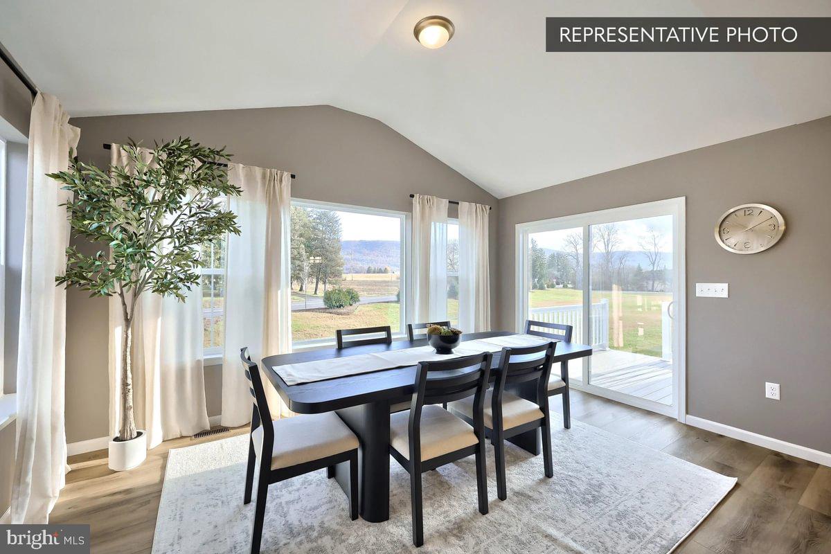 126 Redbud Road Bellefonte, PA 16823 - Photo 10 of 16 a view of a dining room with furniture window and wooden floor