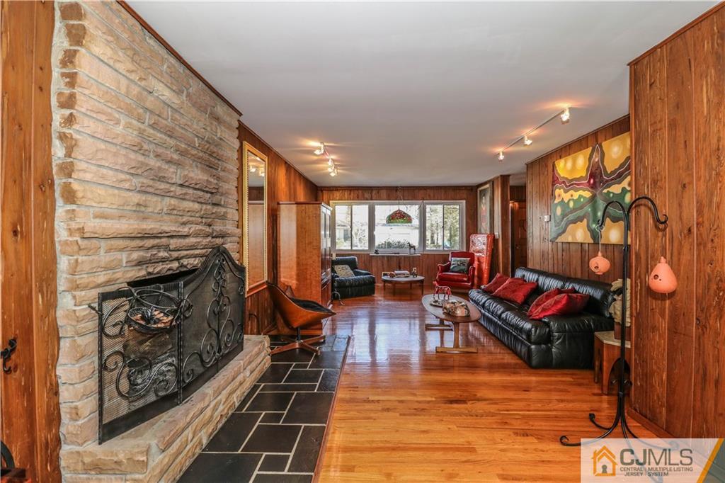 3 Whitewood Road Edison, NJ 08820 - Photo 14 of 28 a living room with furniture a fireplace and wooden floor