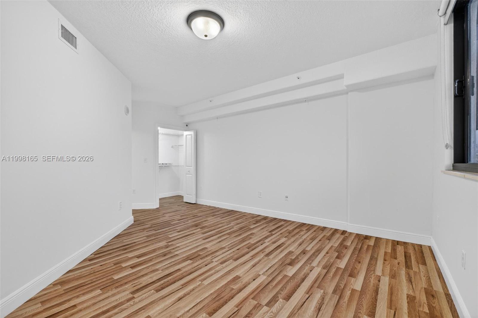 2301 Southwest 27th Avenue, Unit 906 Miami, FL 33145 - Photo 23 of 38 a view of empty room with wooden floor