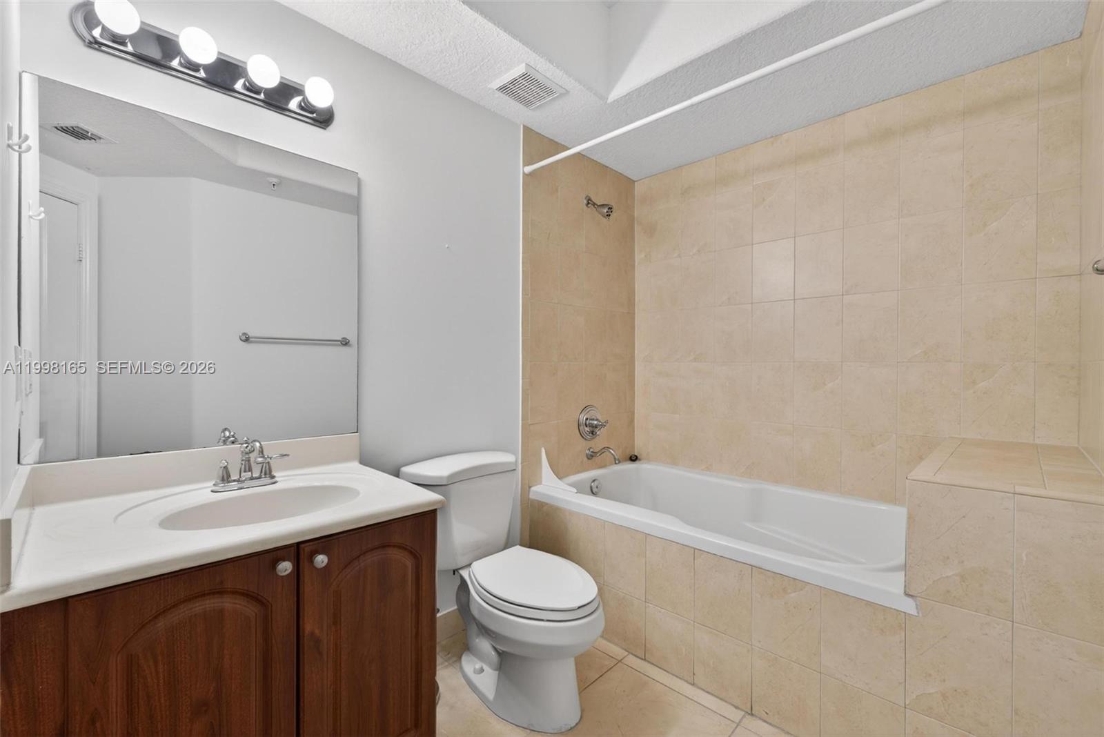 2301 Southwest 27th Avenue, Unit 906 Miami, FL 33145 - Photo 25 of 38 a bathroom with a sink a toilet and shower
